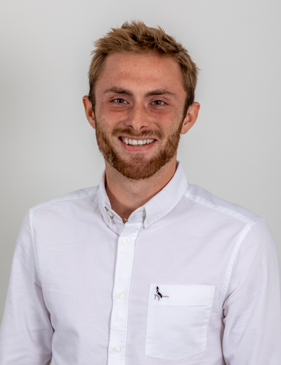 A profile image of a smiling young white man with sandy brown styled hair and beard. He wears a white buttoned shirt.